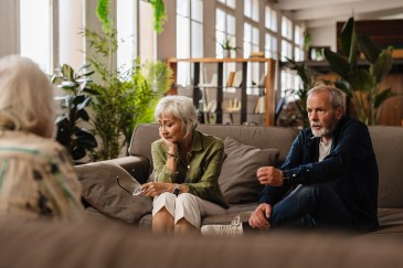 Couple talking to a therapist and looking upset