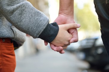 Parent and child holding hands