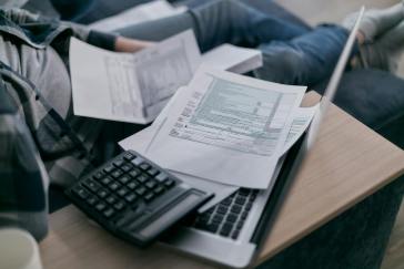 A man trying to fill out financial documents.
