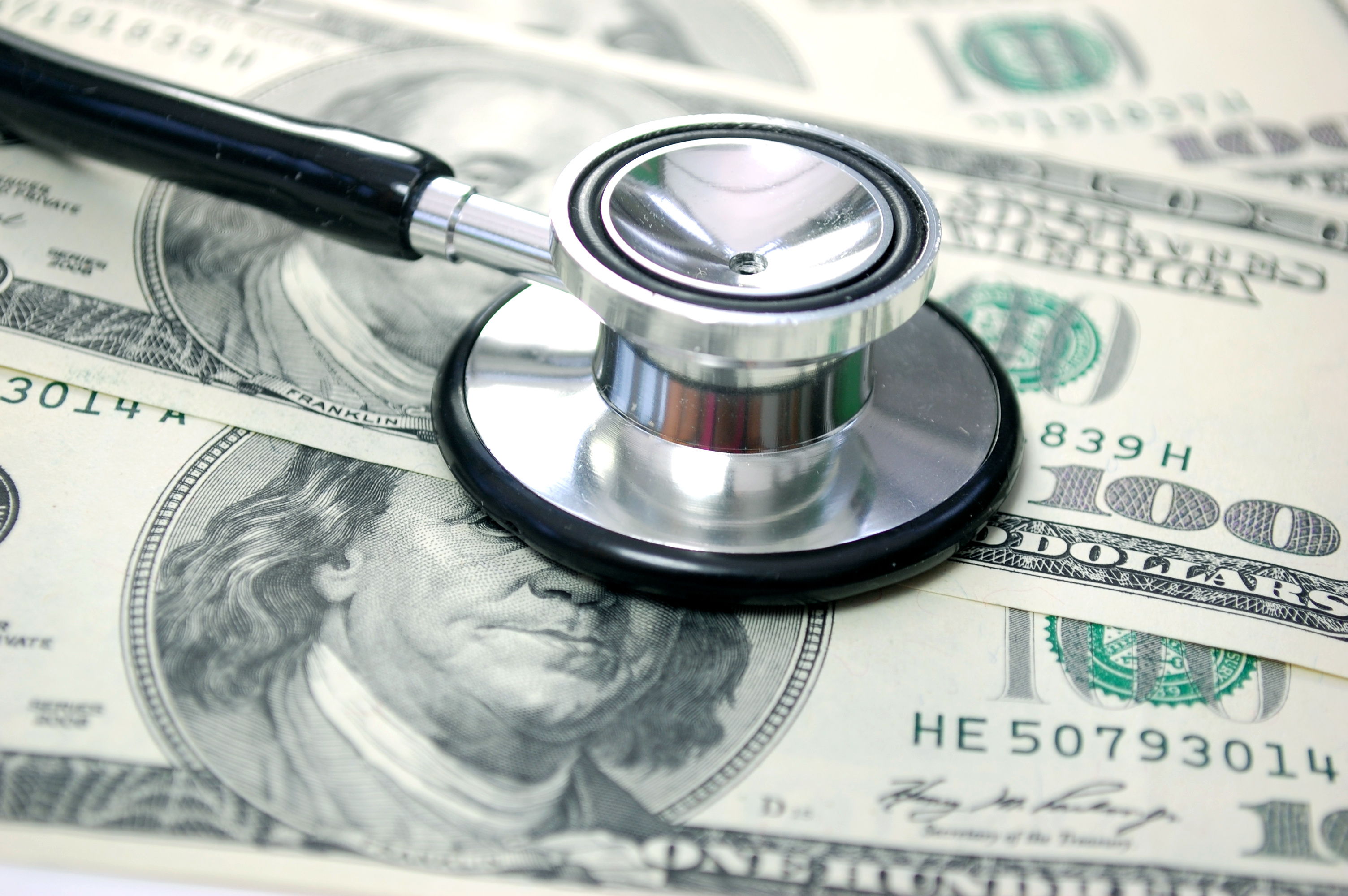 $100 bills with a stethoscope on top