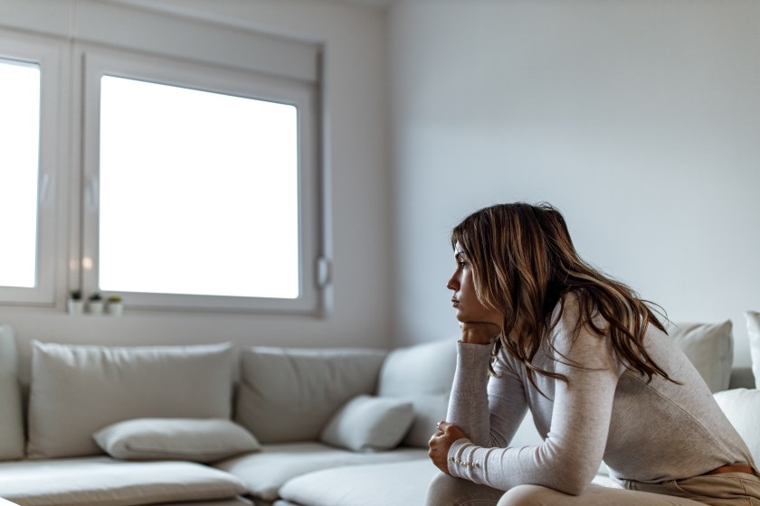 Woman looking upset with her chin in her hands
