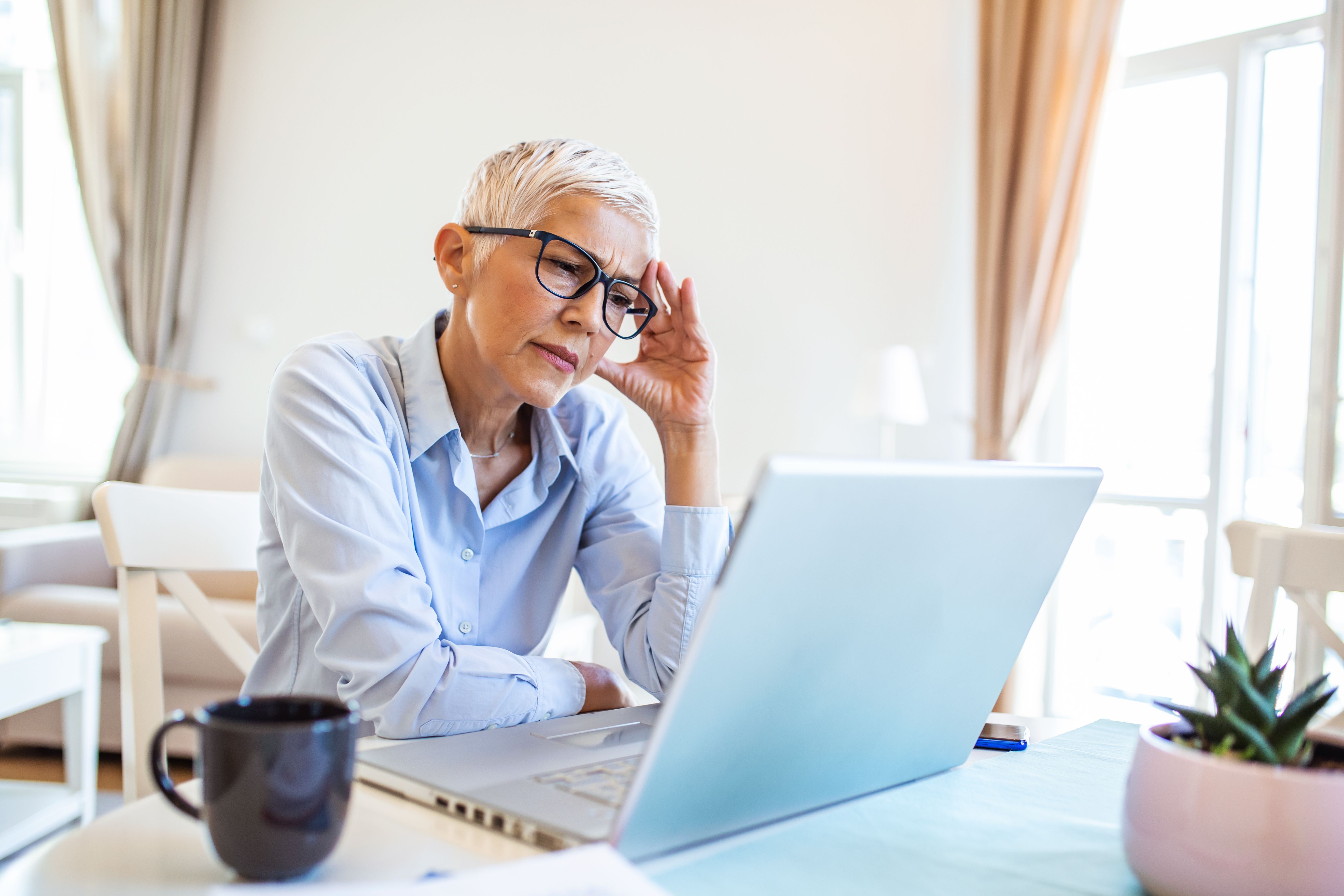 Older woman in front of her computer looking concerned