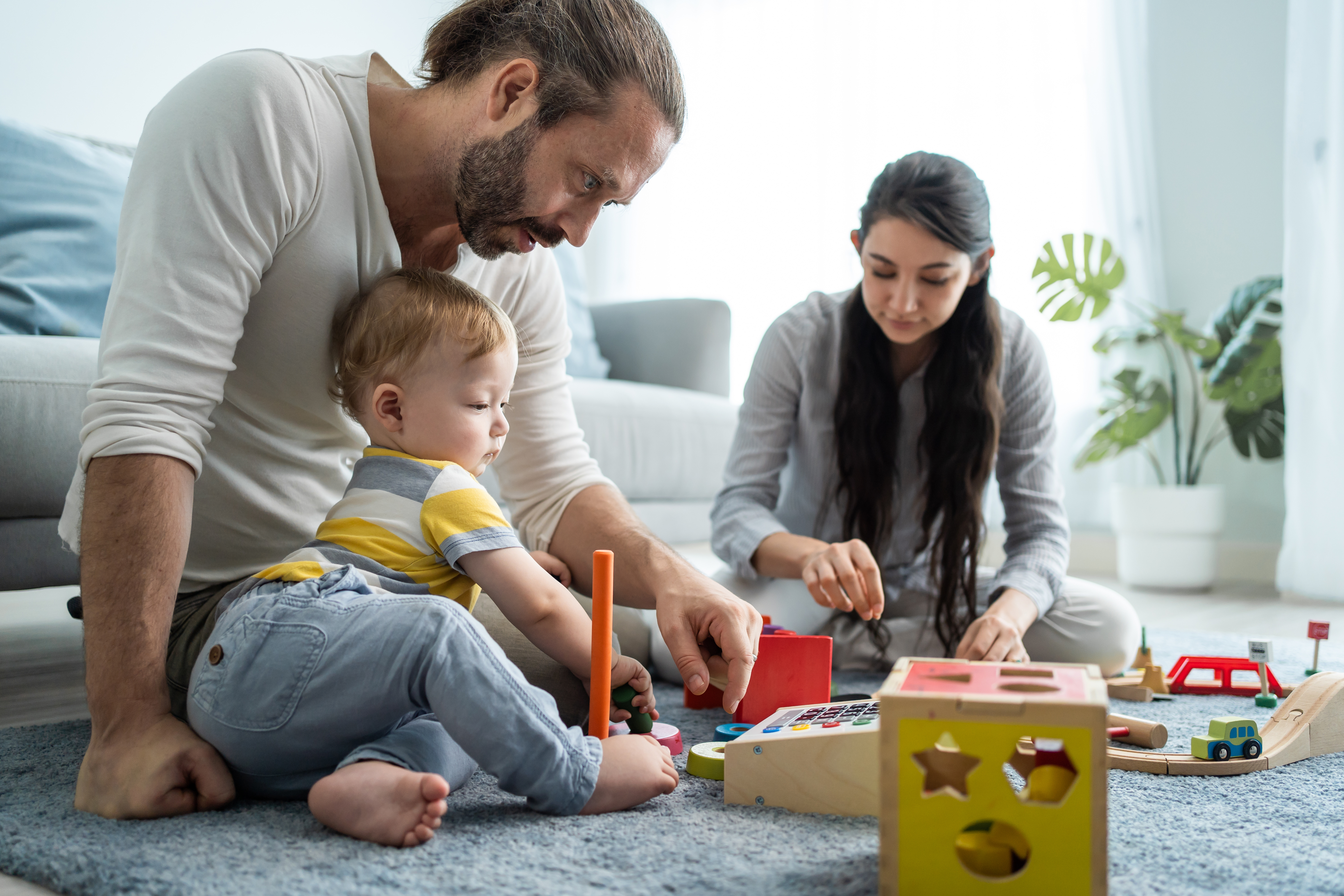 Family playing on the floor with a small child