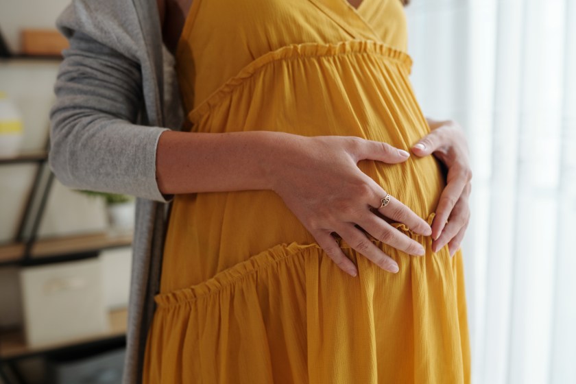 Woman holding her pregnant stomach