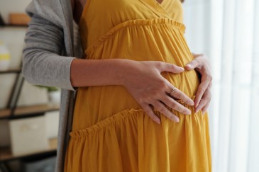 Woman holding her pregnant stomach