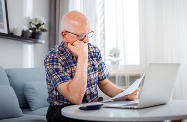 Older man looking confused while sitting at his computer