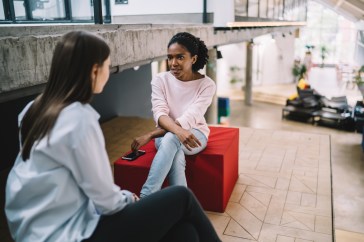 Two female coworkers talking
