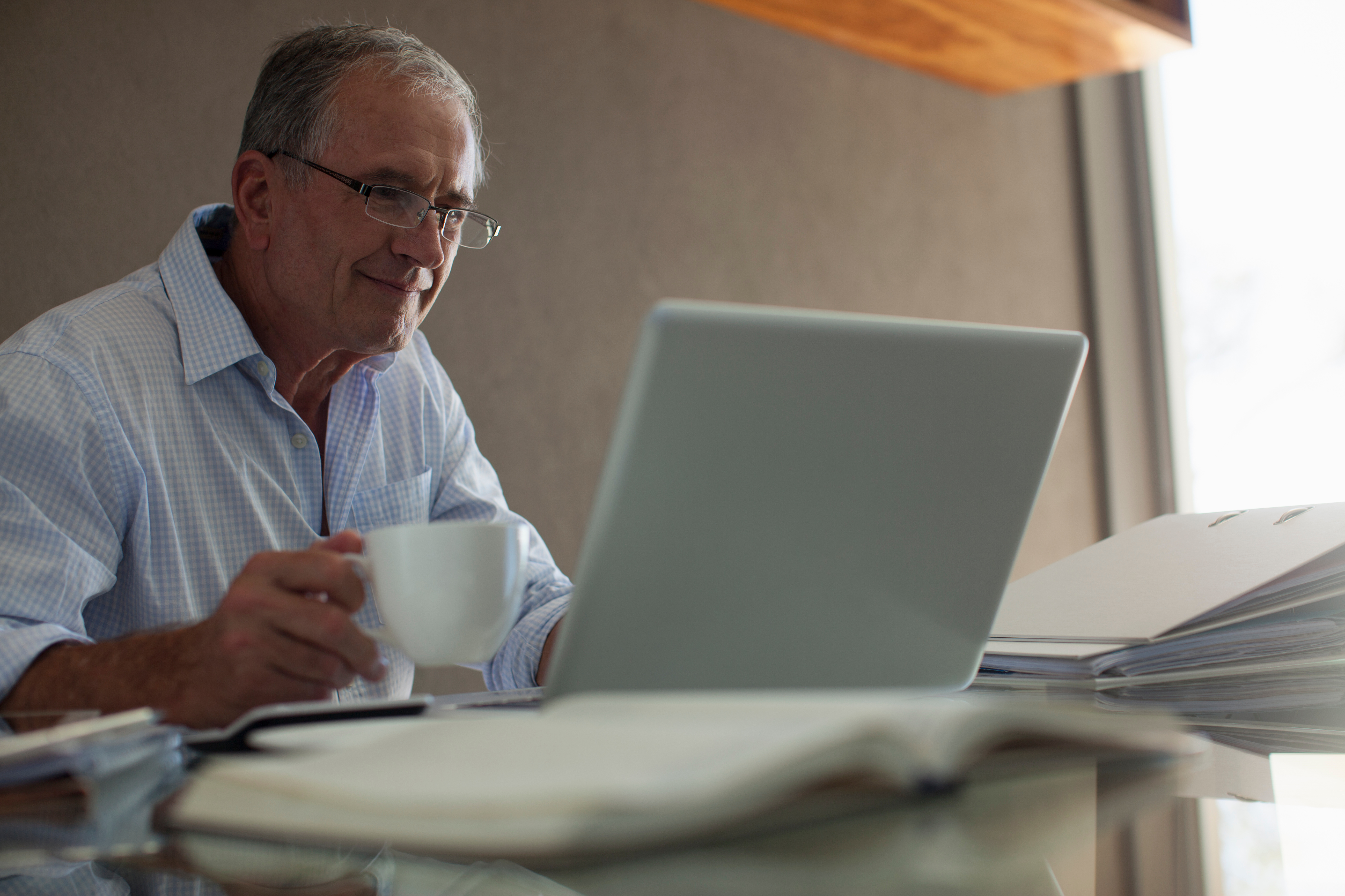 Older man sitting in front of his computer
