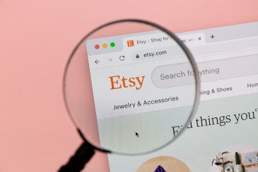 Etsy website, with the search bar at the top; a magnify glass hovers over the left-hand corner of the webpage.