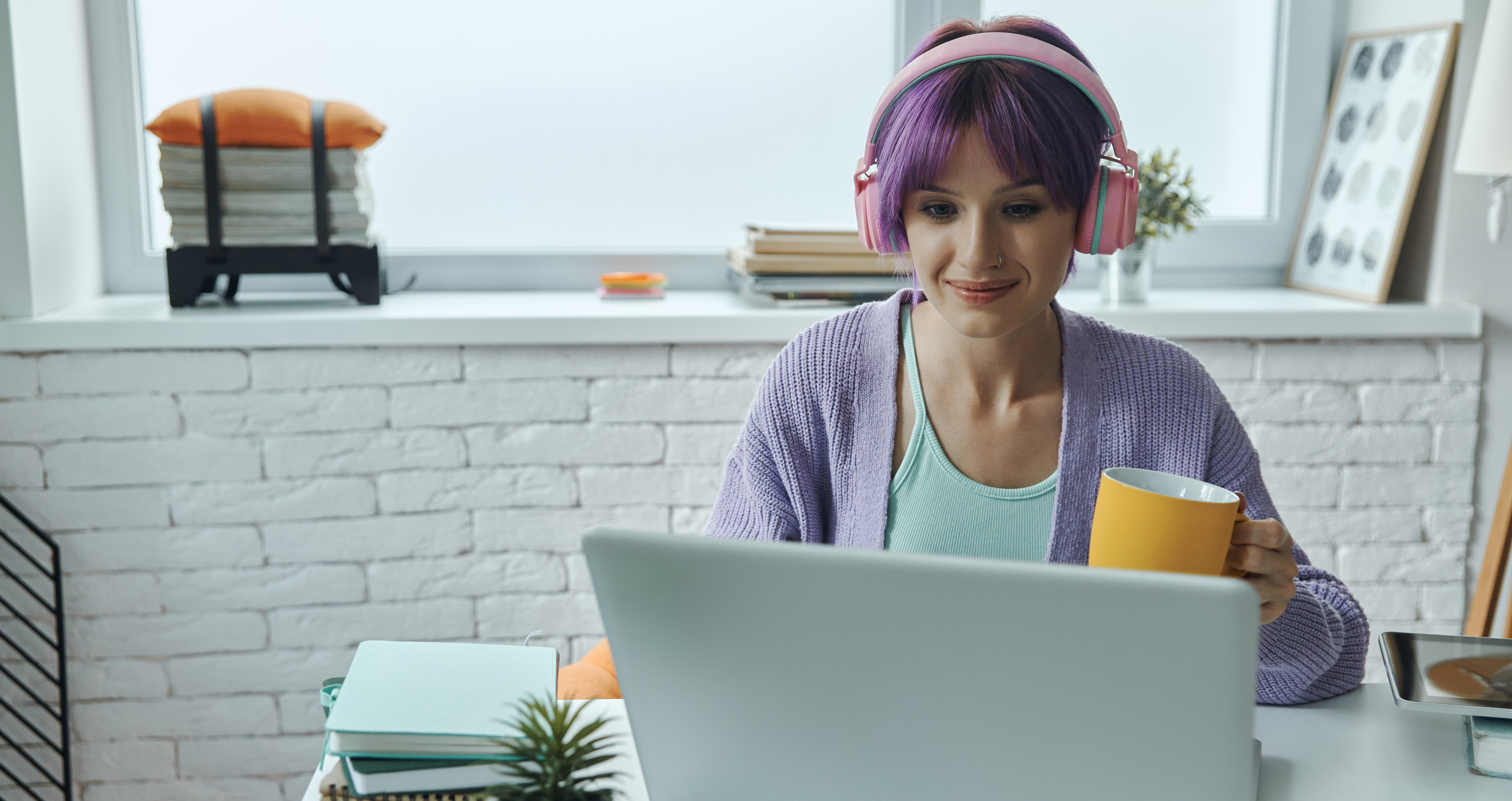 Woman working with noise cancelling headphones.
