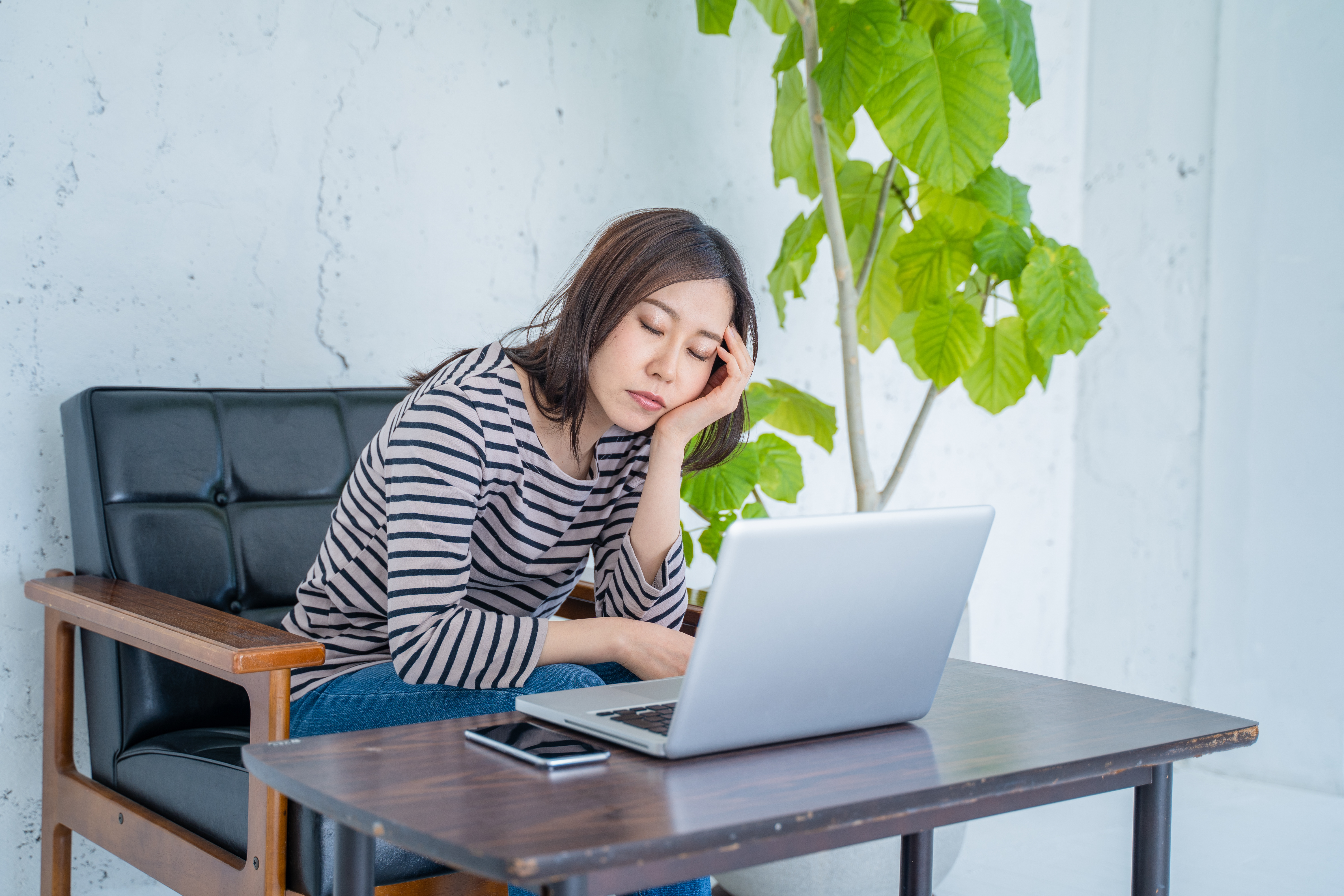 Woman falling asleep at work.