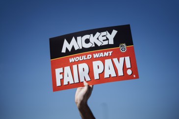 A union sign that says, "Mickey would want fair pay."
