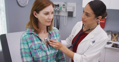 Doctor examining patient with stethescope