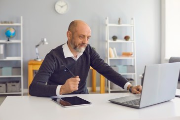Man in office on laptop computer