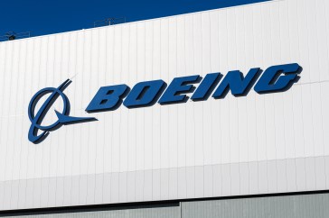 Boeing is written on the side of a white building.