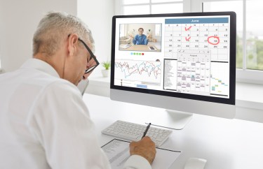 Man facing computer screen with calendar, graf and meeting