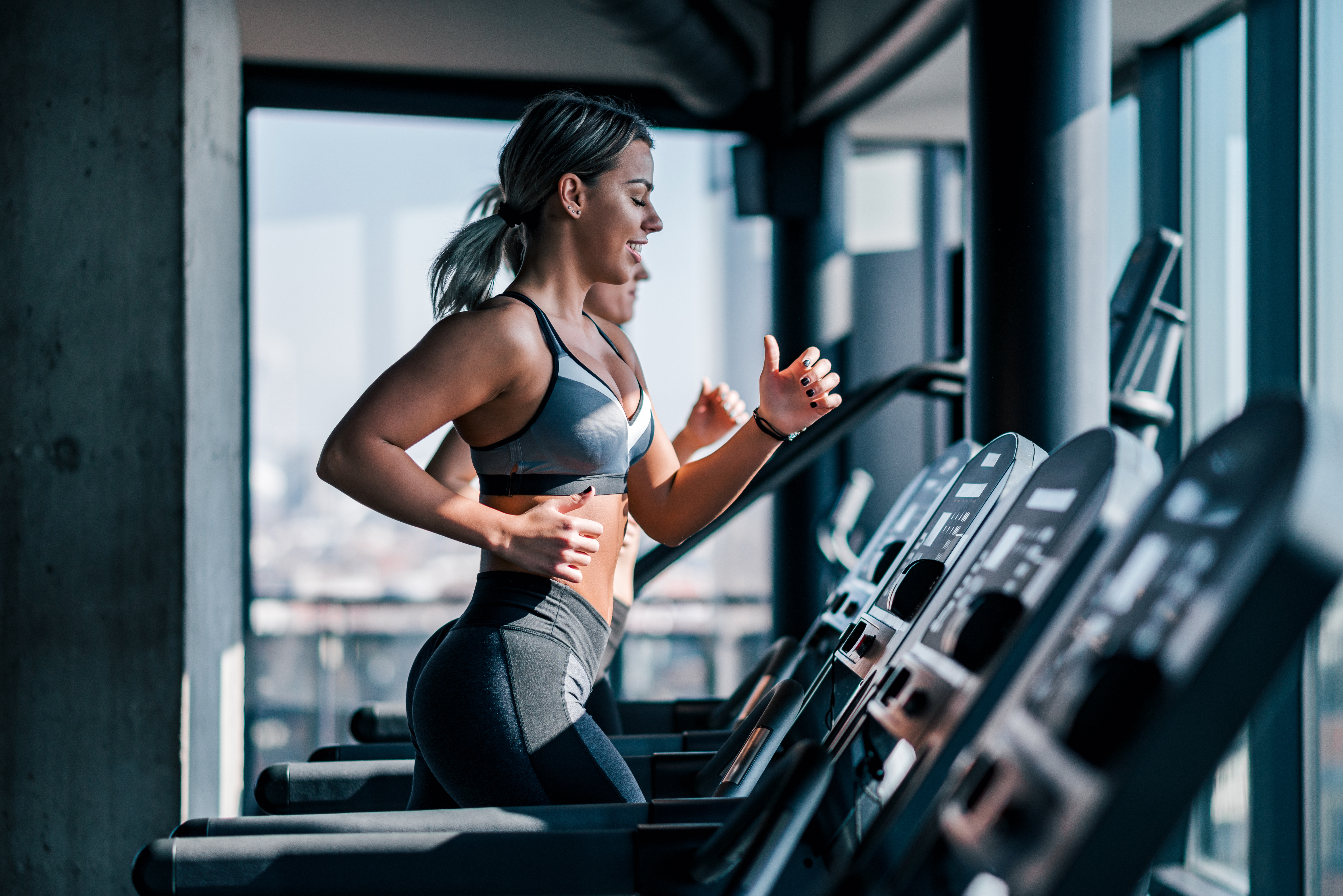 Woman running on treadmill at gym