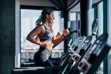 Woman running on treadmill at gym