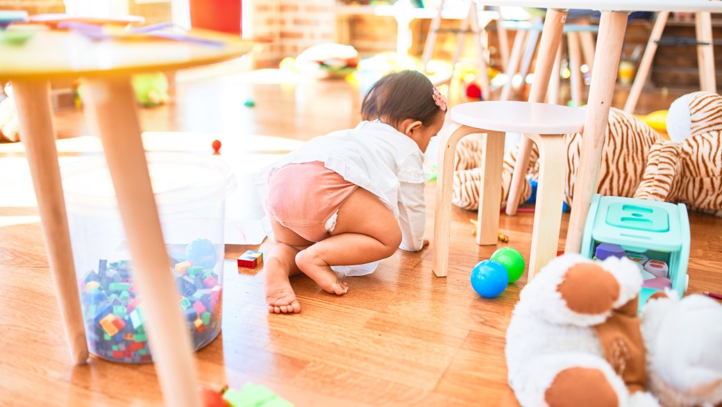 A baby crawling around a daycare center