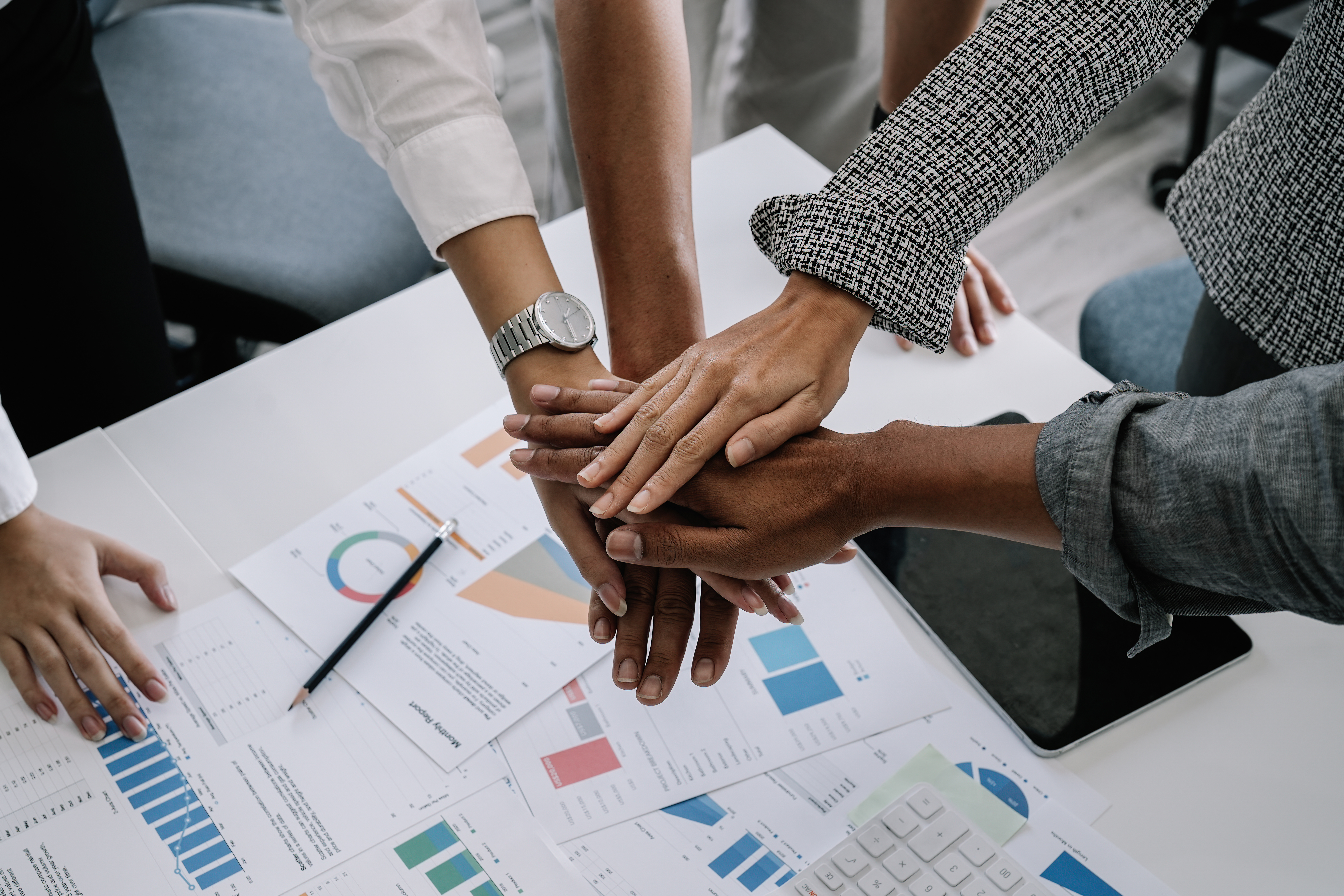 Group of employee hands on top of each other; diverse
