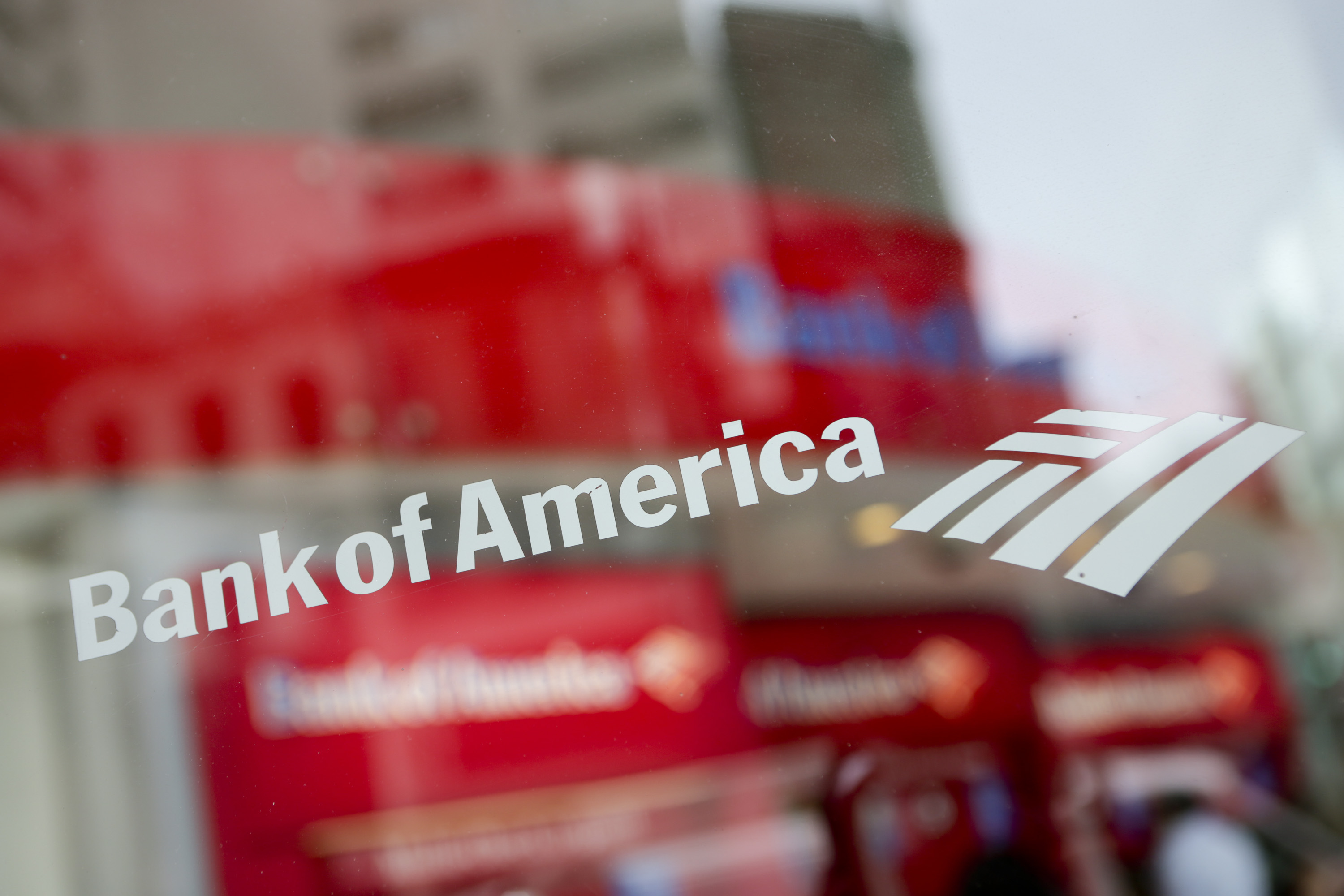 Bank of America is written in white lettering on a glass door.