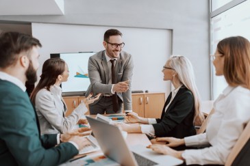 Leader talking to table of employees