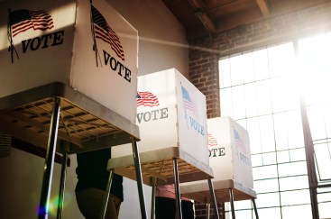Voting poll in sunlit, industrial building.