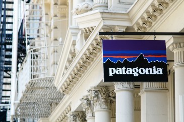 Patagonia store banner hanging outside greco-roman stye building.