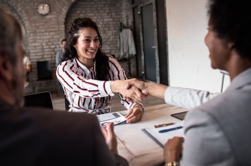 Job interview, women shaking hand, smiling