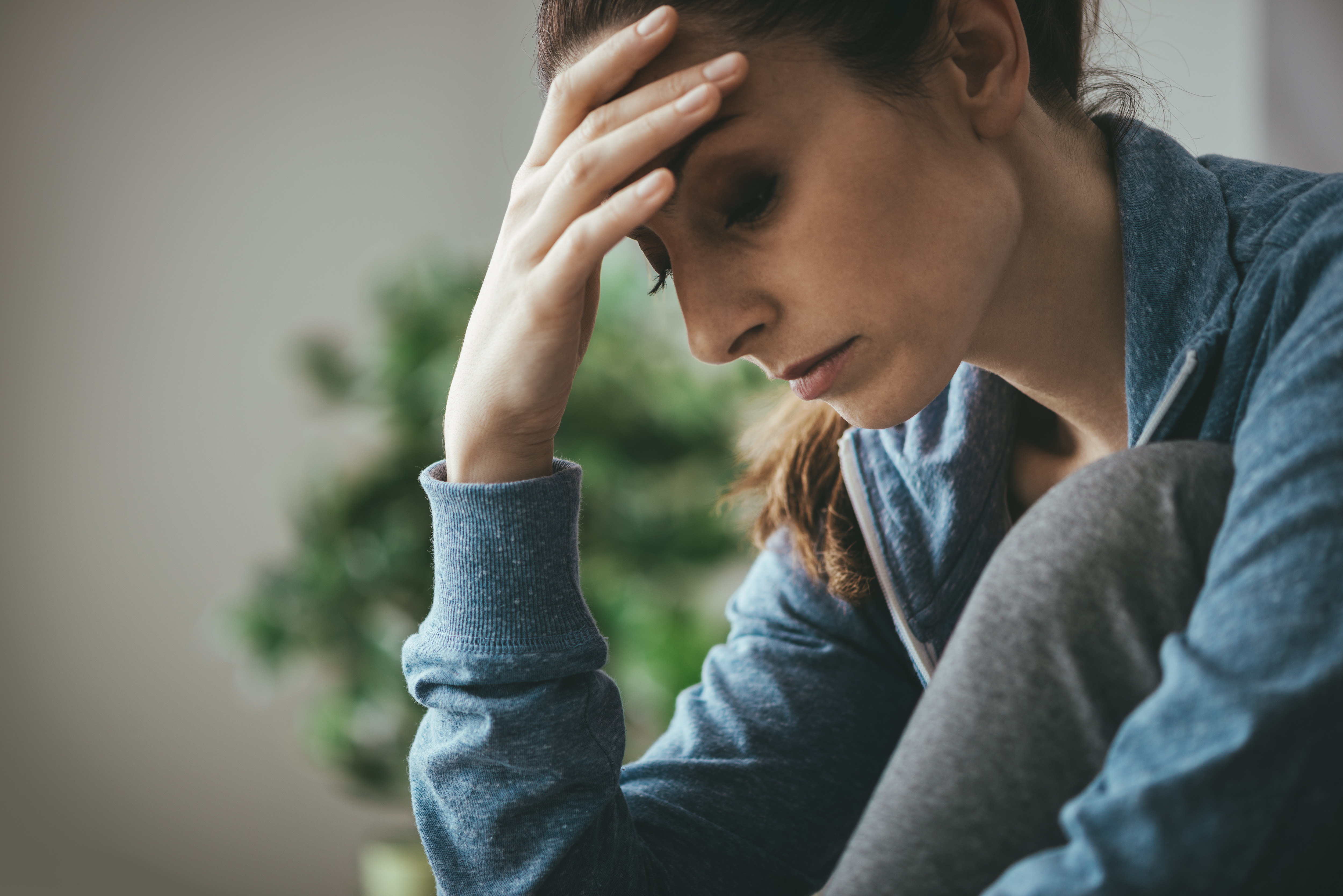 Woman holding head; tired