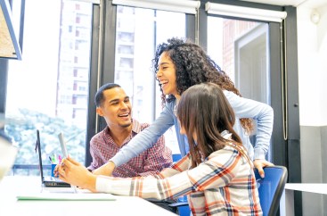 Employees working together on computer