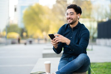 Man sitting outside talking on phone