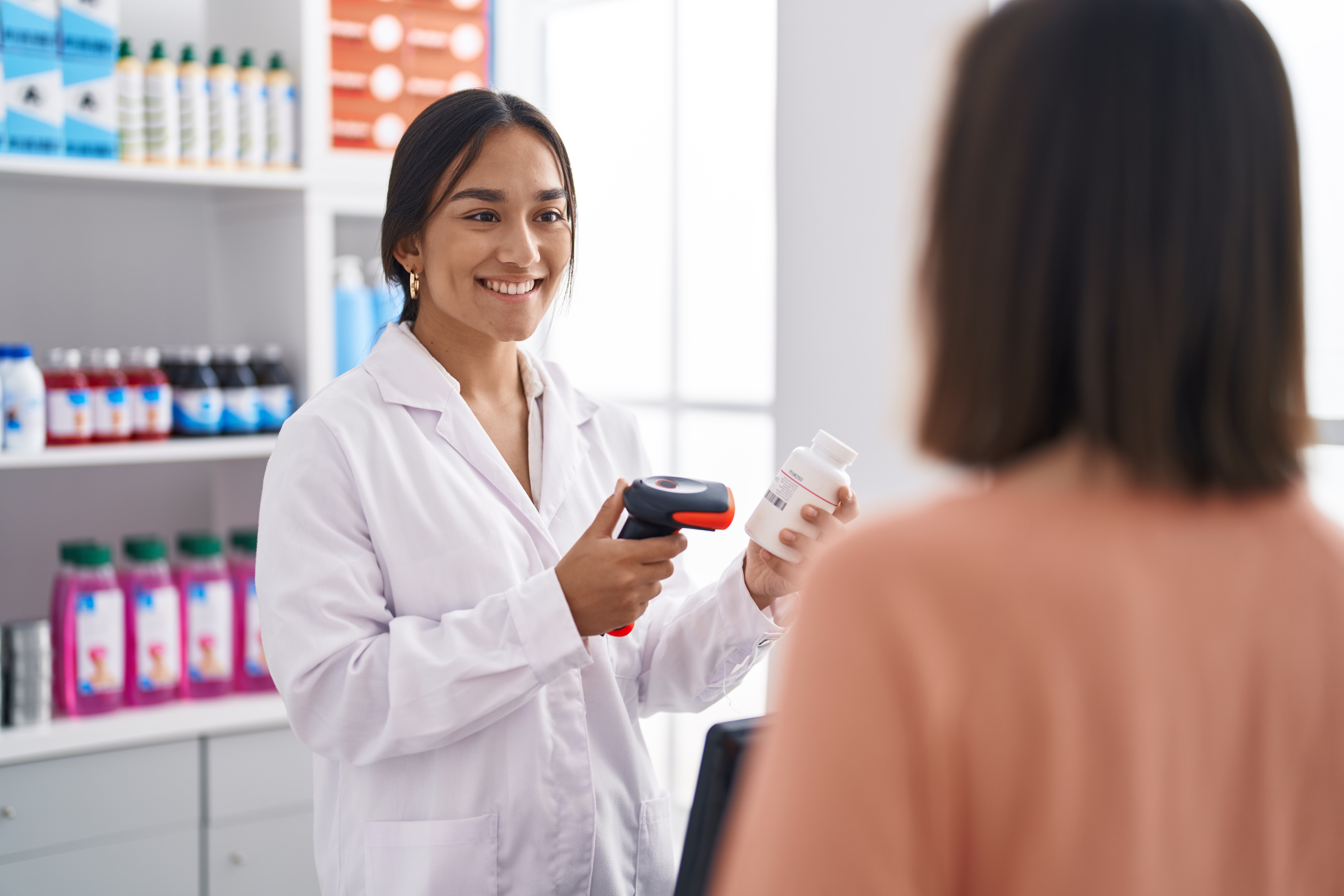 Pharmacist scanning medication for patient