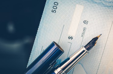 Paycheck with pen