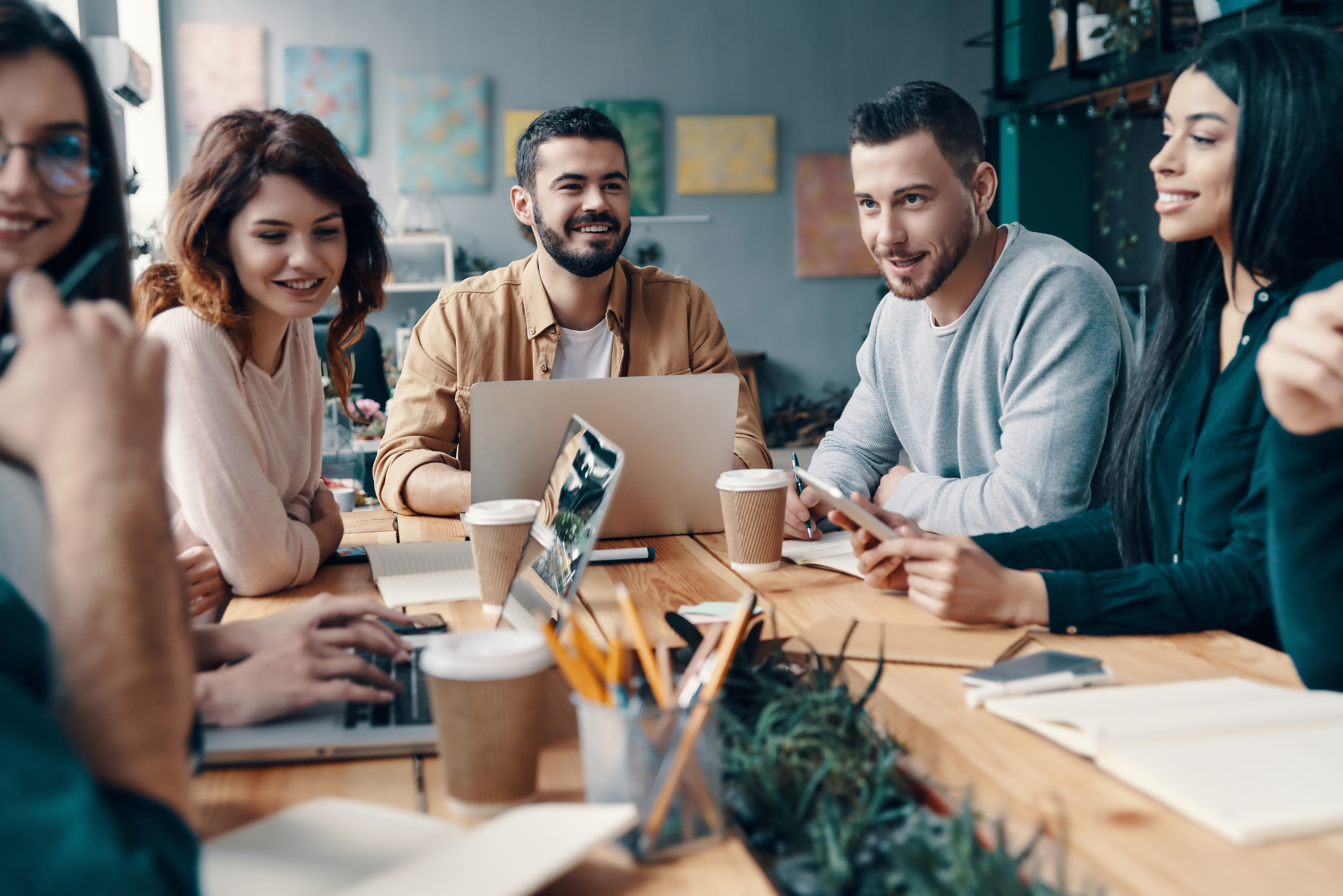 Group of employees working, collaborating at table