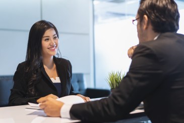 Woman sitting in job interview smiling