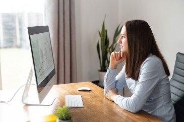 Woman looking at graph on her computer