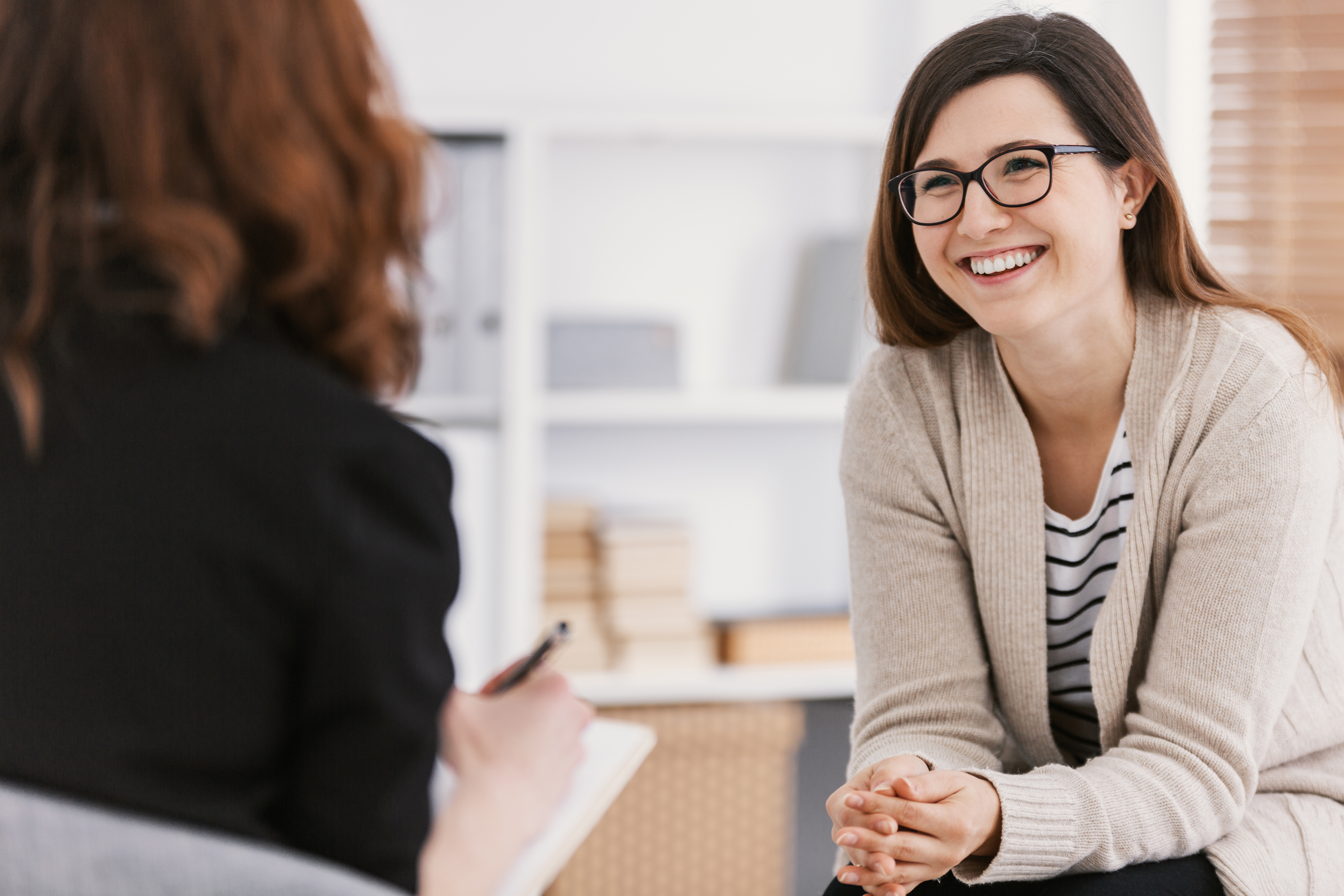 Two women talking, sitting, therapy session