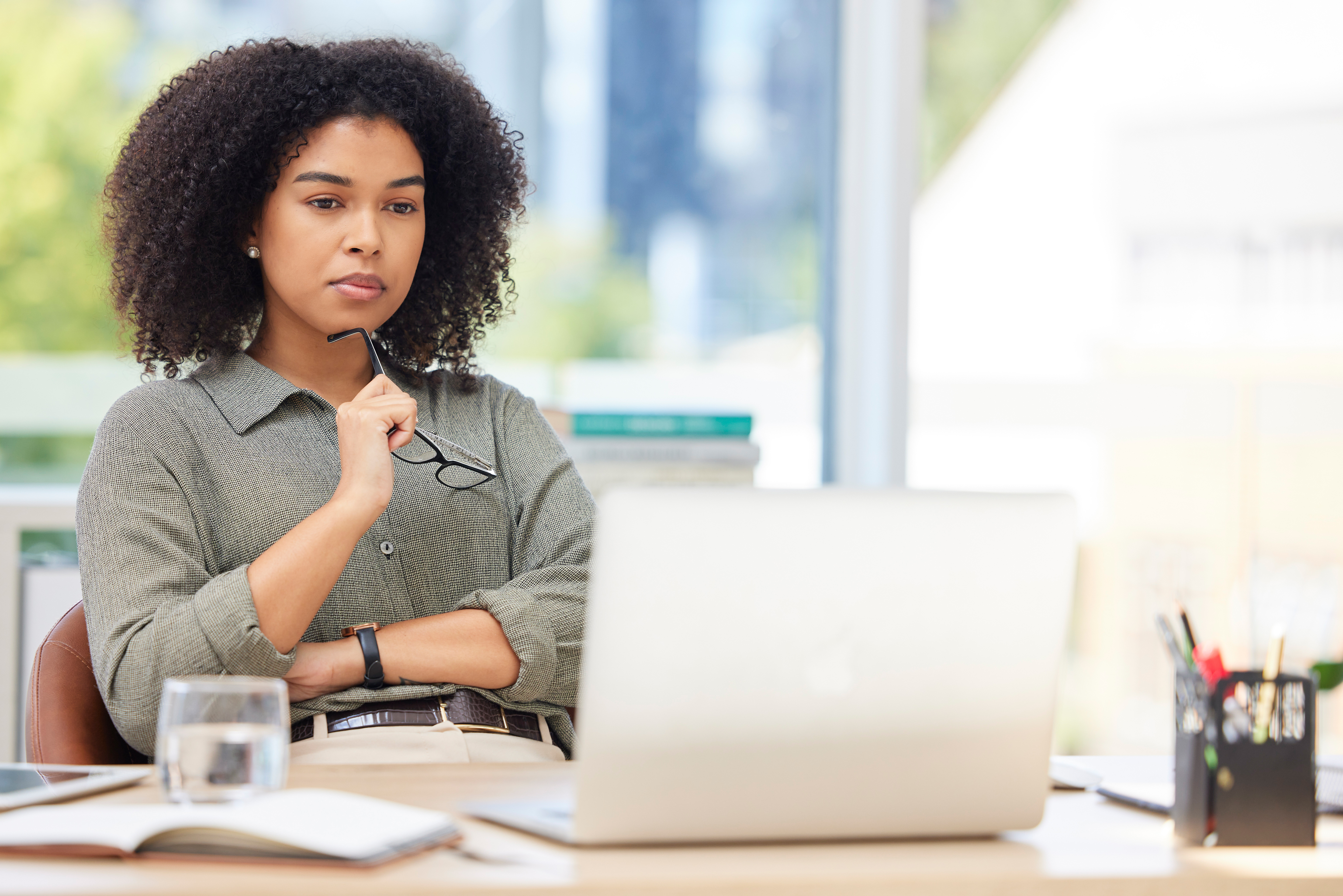 Woman sitting at desk looking at computer
