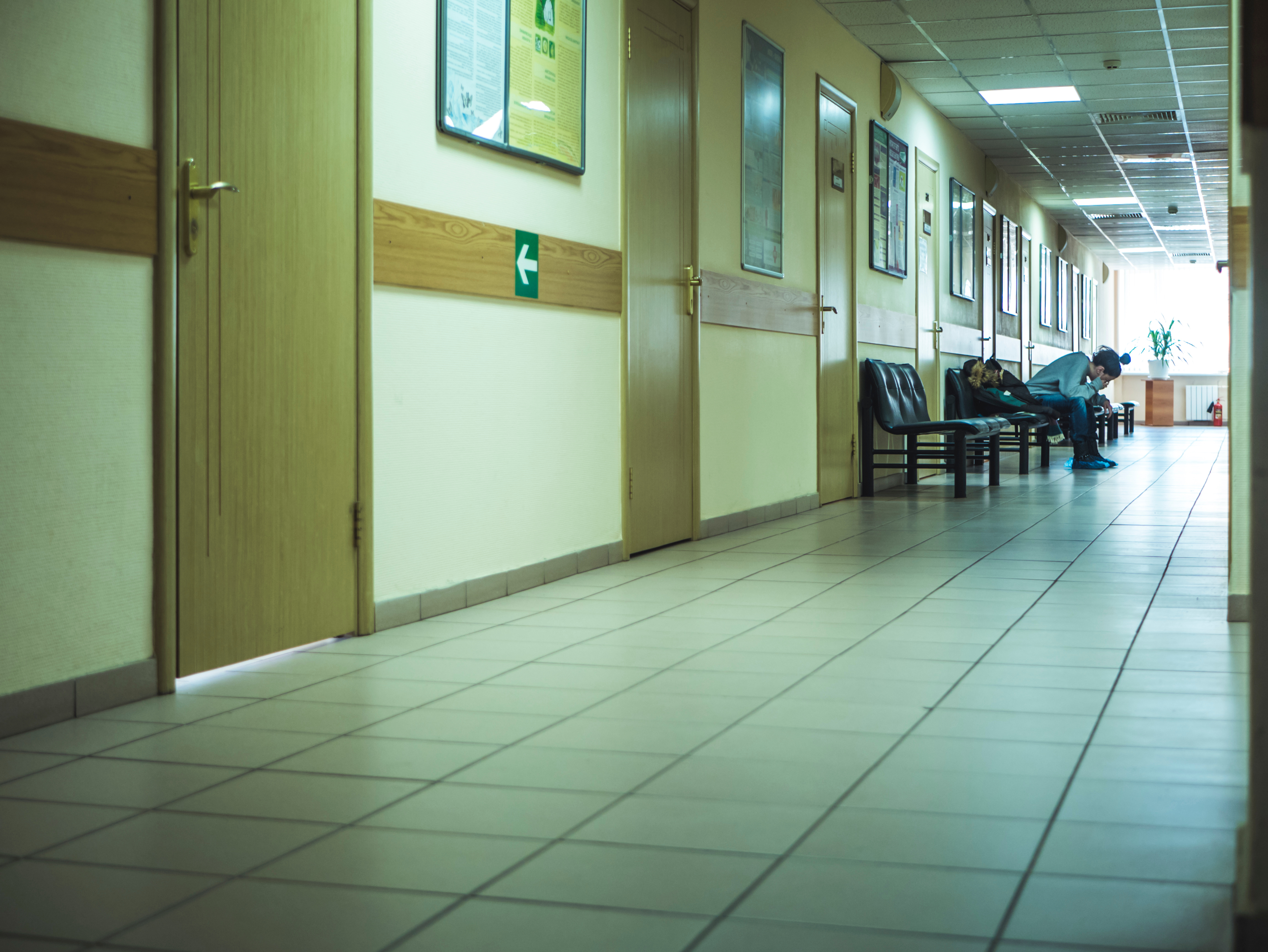 Person sitting in waiting area of hospital