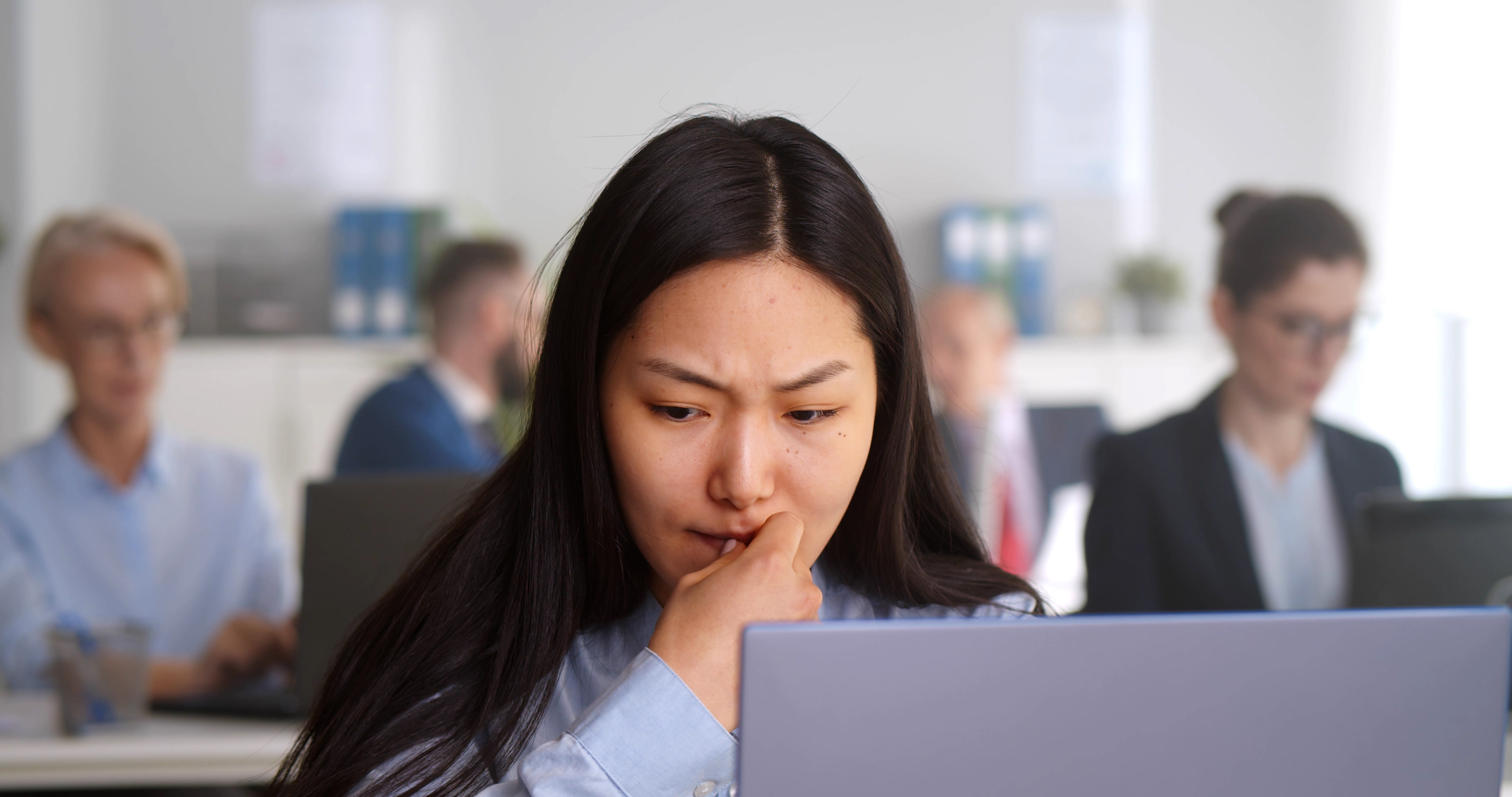 Woman starting at computer, thinking