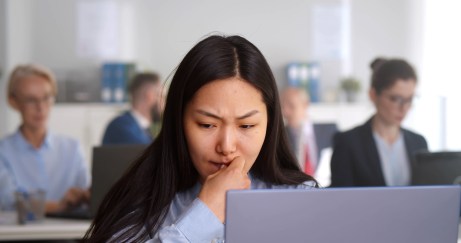 Woman starting at computer, thinking