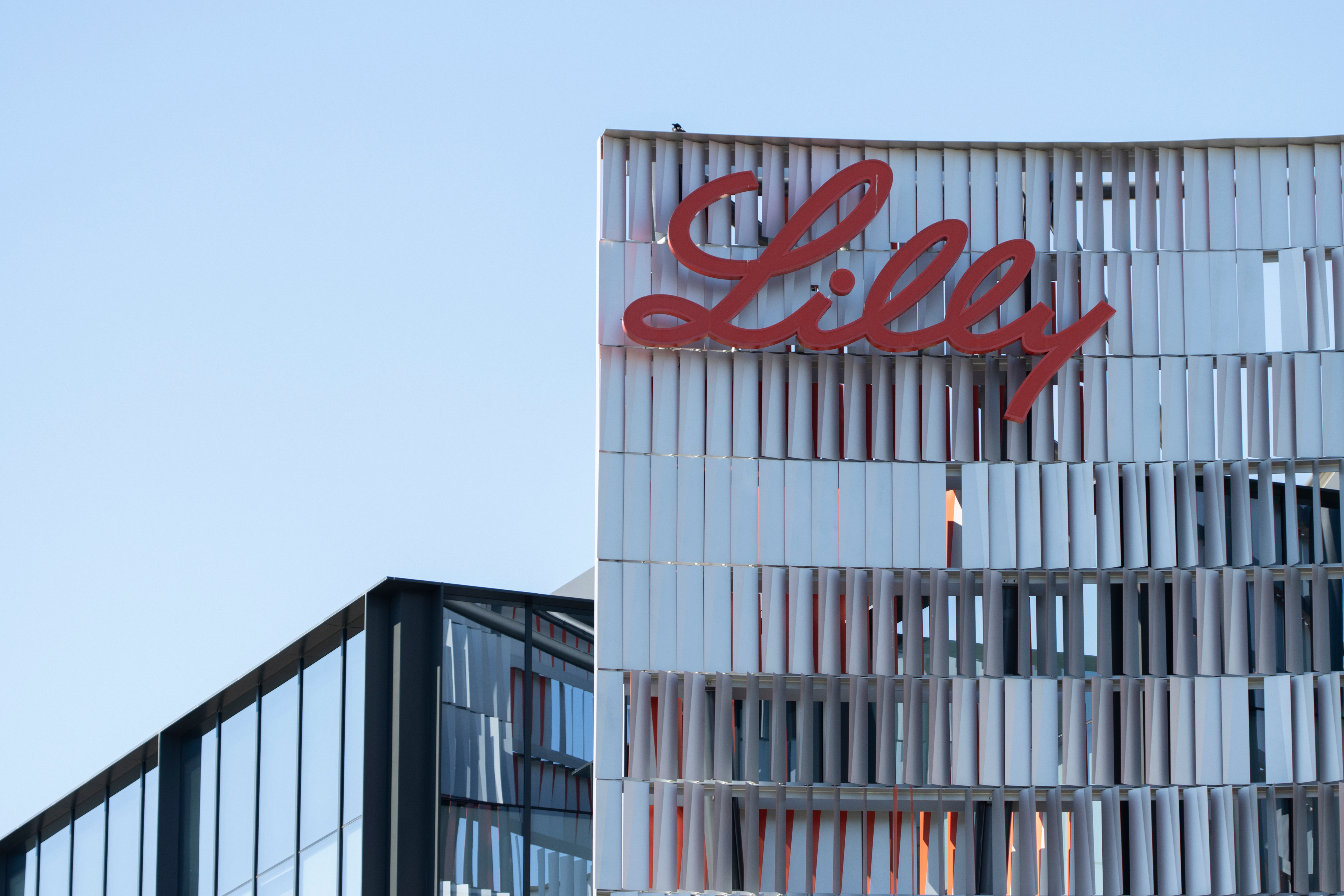 Eli Lilly's corporate headquarters is in San Diego; it is a skyscraper with "Lilly" written in red cursive at the top.