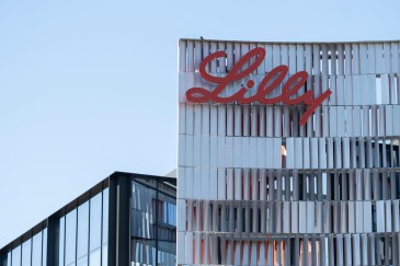 Eli Lilly's corporate headquarters is in San Diego; it is a skyscraper with "Lilly" written in red cursive at the top.
