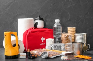 Collection of emergency supplies, medical kit, water, flashlight