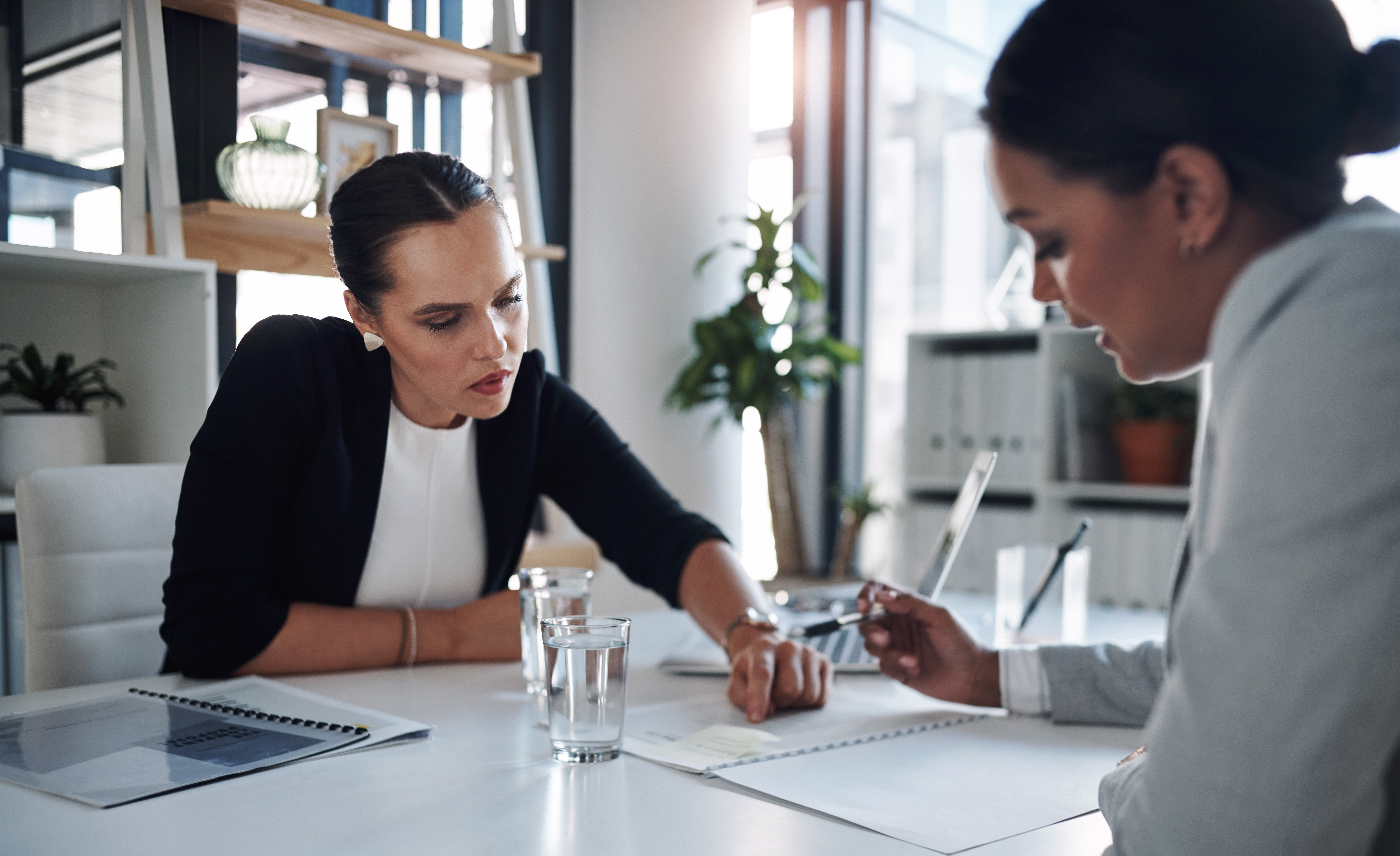Two women in office going over paperwork