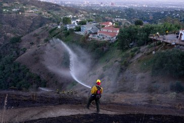Fire fighter spraying water