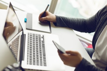 Woman using various technology at work