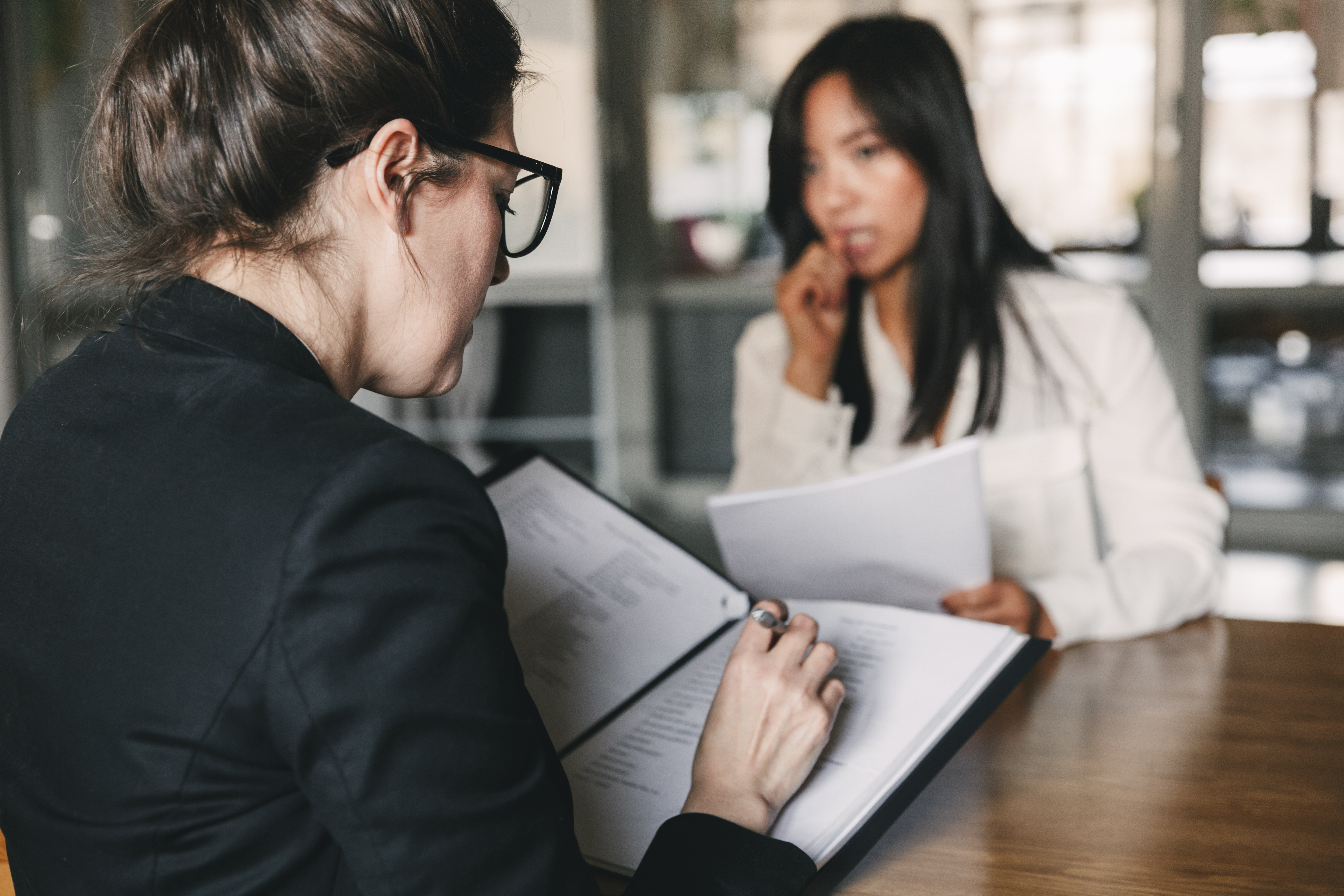 Woman sitting in a job interview looking pensive