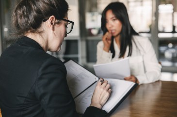 Woman sitting in a job interview looking pensive